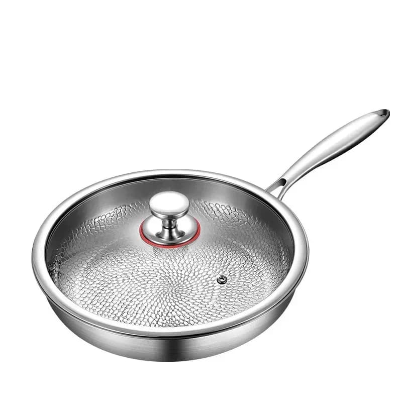 uncoated titanium frying pan with glass lid and hammered cooking surface